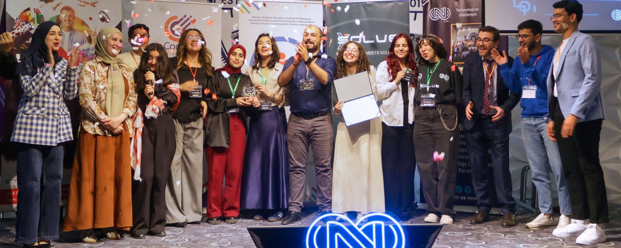 The SolveX 2.0 team celebrating on stage with confetti